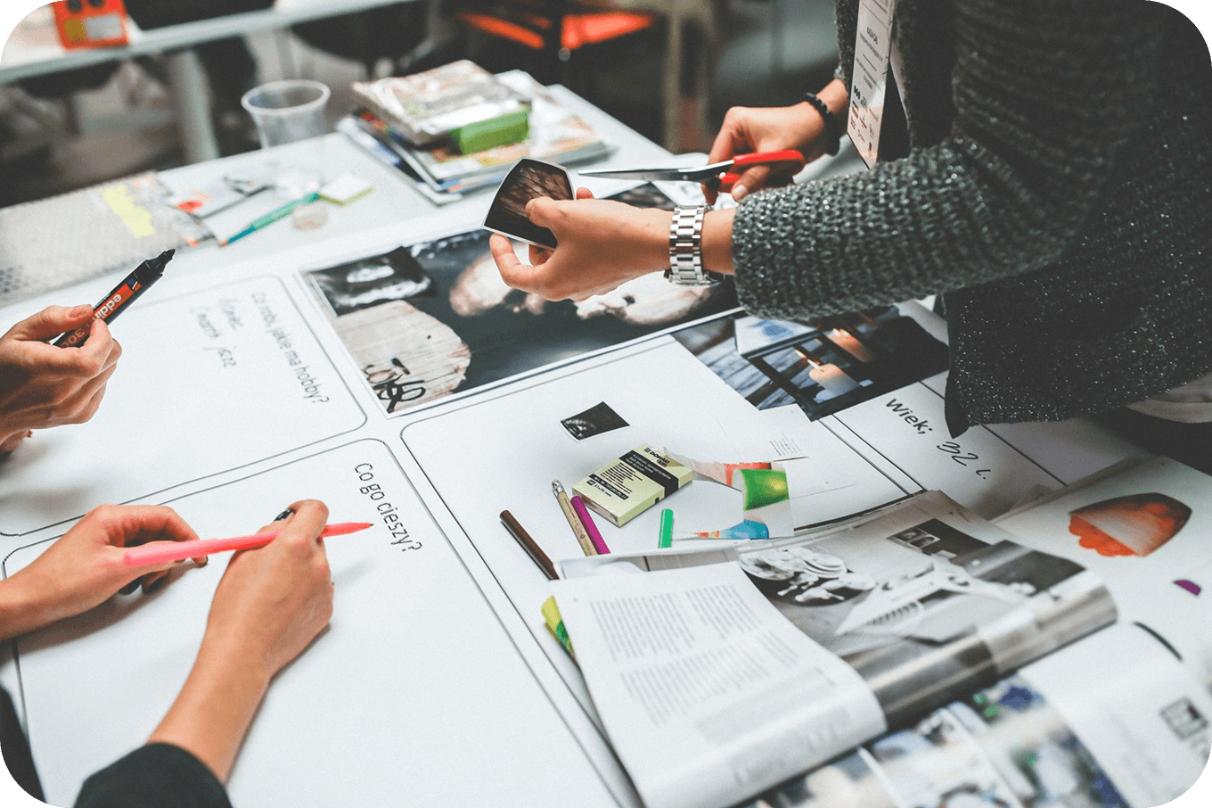 A team cutting up and arranging photos and notes on a brand moodboard