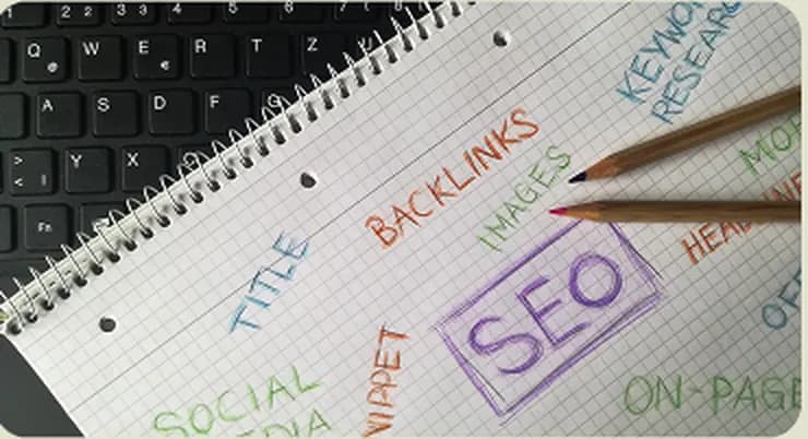 A notebook of content and SEO planning beside a keyboard
